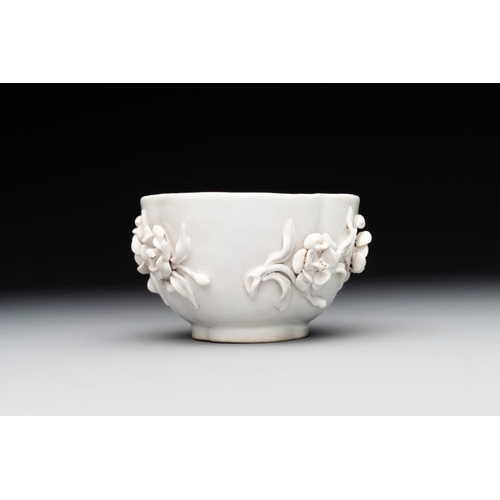 253 - A Chinese blue and white 'butterfly' cup and saucer with applied floral design, QianlongL.: 7,8 cm -... 