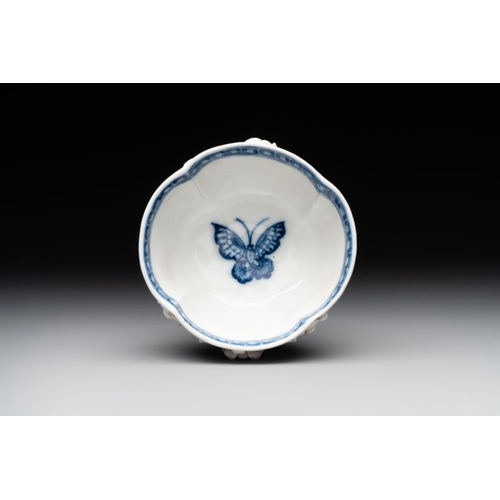 253 - A Chinese blue and white 'butterfly' cup and saucer with applied floral design, QianlongL.: 7,8 cm -... 