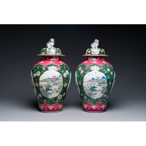 304 - A pair of Chinese famille rose black-ground jars and covers with mountainous landscape design, Yongz... 