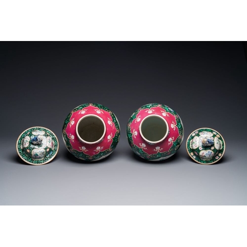 304 - A pair of Chinese famille rose black-ground jars and covers with mountainous landscape design, Yongz... 