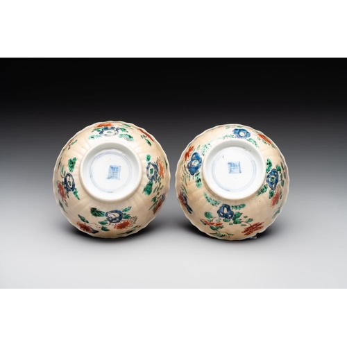 343 - A pair of Chinese famille verte cafe-au-lait-ground cups and saucers, KangxiDia.: 13 cm (the saucers... 