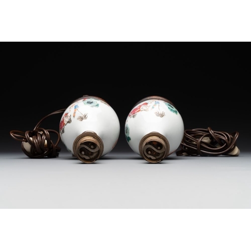 357 - A pair of Chinese famille rose vases with figural design mounted as lamps, 19th C.H.: 20,5 cmThe abs... 