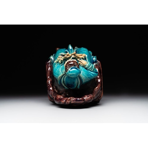 399 - A Chinese turquoise- and aubergine-glazed sculpture of a seated scholar, 18/19th C.Dim.: 10 x 12 x 1... 