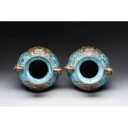 414 - A pair of Chinese robin's egg and faux bronze-glazed 'hu' vases, Qianlong mark, 19th C.H.: 37,8 cmTh... 