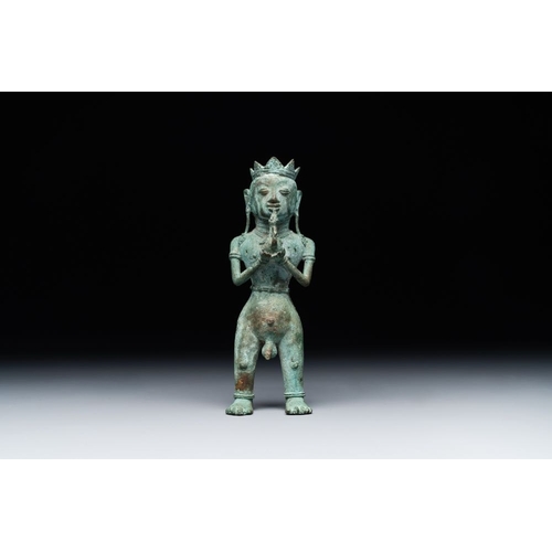 461 - An fine Indonesian bronze sculpture of a naked man offering a sacrificial vase, Majapahit, East Java... 