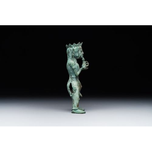 461 - An fine Indonesian bronze sculpture of a naked man offering a sacrificial vase, Majapahit, East Java... 