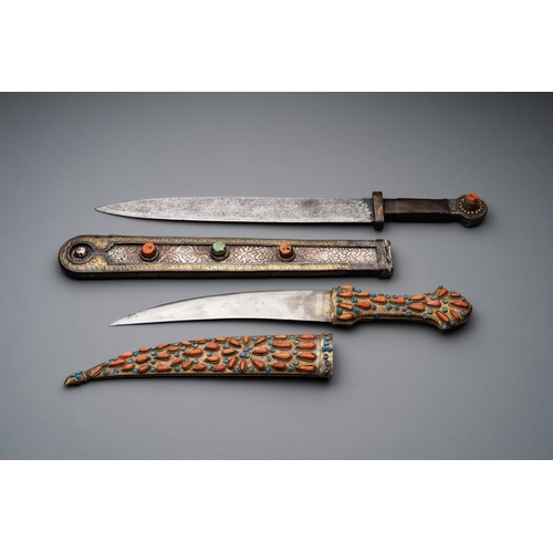 487 - A varied collection of four decorated daggers, two inset with red coral and turquoise, Sri Lanka and... 