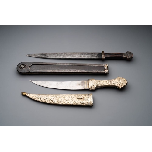 487 - A varied collection of four decorated daggers, two inset with red coral and turquoise, Sri Lanka and... 