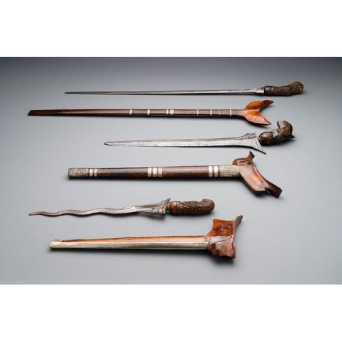 488 - A collection of six krises with carved handles, four with scabbard, Indonesia, 19th C.L.: 67 cm (the... 