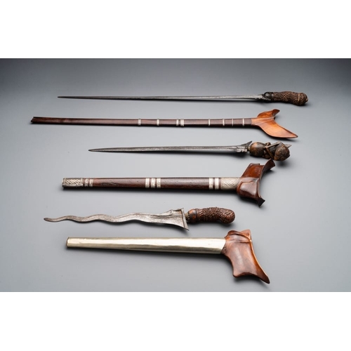 488 - A collection of six krises with carved handles, four with scabbard, Indonesia, 19th C.L.: 67 cm (the... 