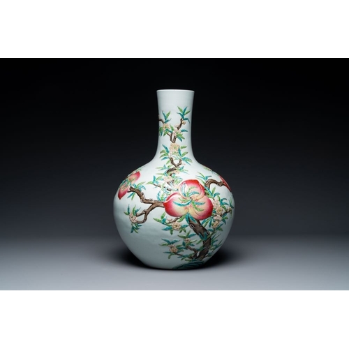 737 - A Chinese famille rose relief-moulded 'tianqiuping' vase with nine peaches, Qianlong mark, 19/20th C... 