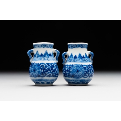 758 - A pair of Chinese blue and white miniature 'hu' vases on wooden stands, Kangxi mark, 19th C.H.: 5,8 ... 