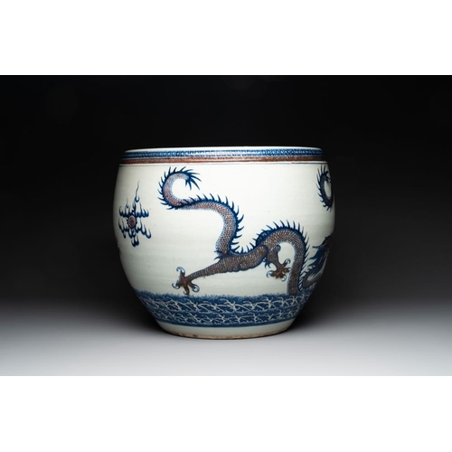 925 - A pair of Chinese blue, white and copper-red 'dragon' fish bowls, QianlongDia.: 47,5 cm - H.: 39 cmT... 