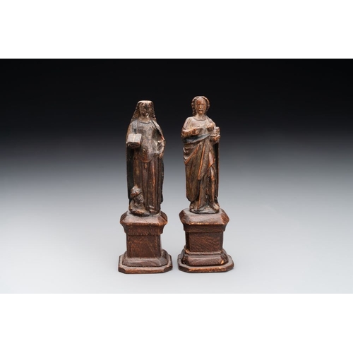 975 - Two parcel-gilt and polychromed miniature oak sculptures of Saint John The Evangelist and Saint Cath... 