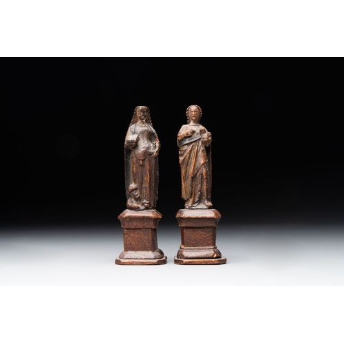 975 - Two parcel-gilt and polychromed miniature oak sculptures of Saint John The Evangelist and Saint Cath... 