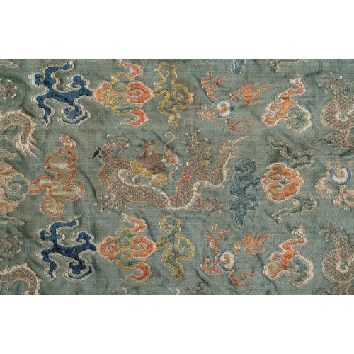 1059 - A Chinese green-ground embroidered silk panel with dragons among clouds, 18th C.Dim.: 70 x 80 cm... 