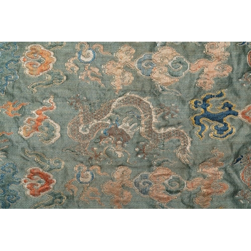 1059 - A Chinese green-ground embroidered silk panel with dragons among clouds, 18th C.Dim.: 70 x 80 cm... 