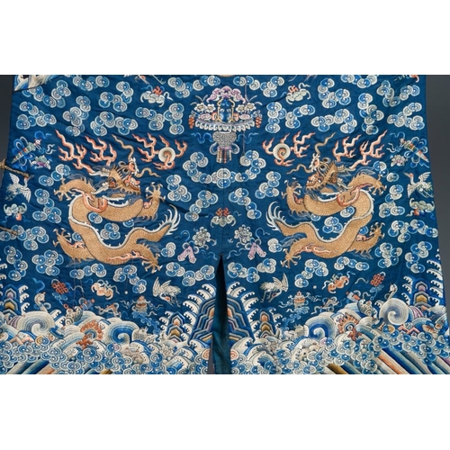 1062 - A Chinese gold thread embroidered blue-ground silk 'dragon' robe, 19th C.Dim.:226,5 x 140 cm
... 