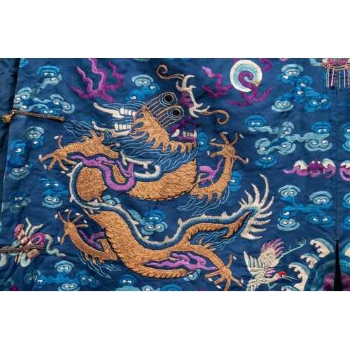 1063 - A Chinese gold thread embroidered blue-ground silk 'dragon' robe, 19th C.Dim.: 225 x 135 cm... 