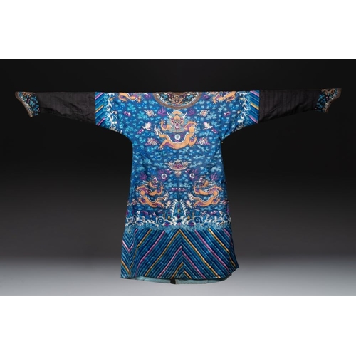 1063 - A Chinese gold thread embroidered blue-ground silk 'dragon' robe, 19th C.Dim.: 225 x 135 cm... 