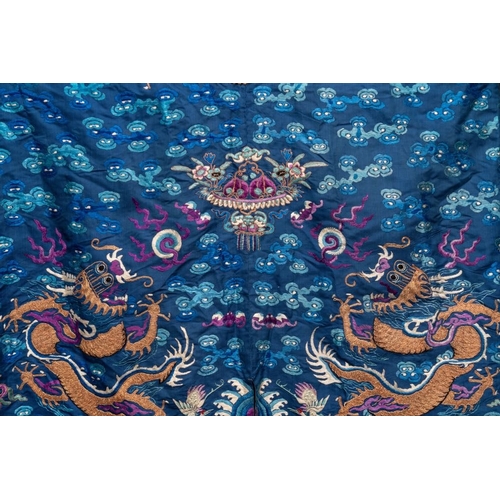 1063 - A Chinese gold thread embroidered blue-ground silk 'dragon' robe, 19th C.Dim.: 225 x 135 cm... 