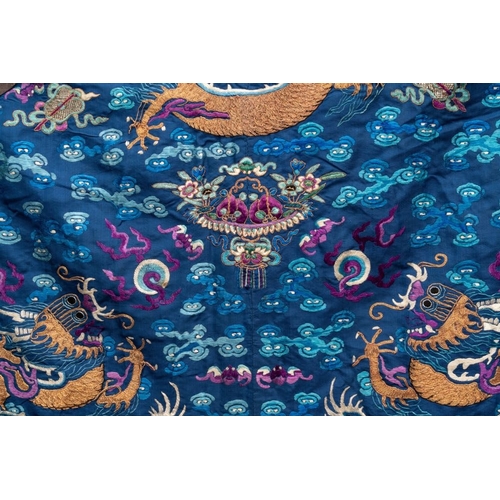 1063 - A Chinese gold thread embroidered blue-ground silk 'dragon' robe, 19th C.Dim.: 225 x 135 cm... 