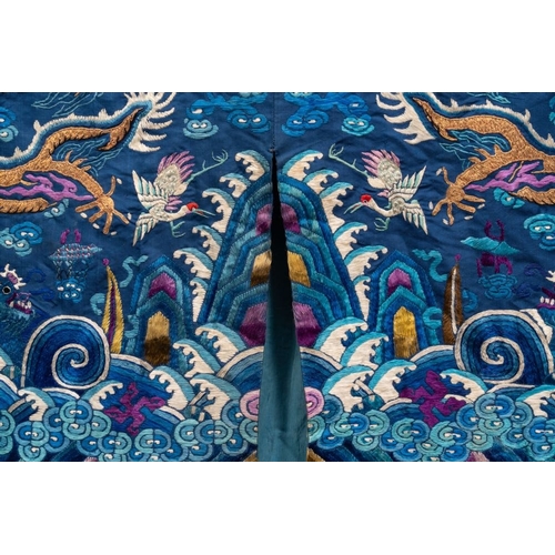 1063 - A Chinese gold thread embroidered blue-ground silk 'dragon' robe, 19th C.Dim.: 225 x 135 cm... 