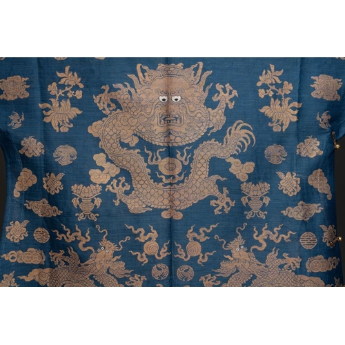 1064 - A Chinese embroidered silk blue-ground summer gauze 'nine dragons' robe, 19th C.Dim.: 215 x 130 cm... 