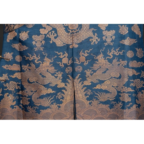 1064 - A Chinese embroidered silk blue-ground summer gauze 'nine dragons' robe, 19th C.Dim.: 215 x 130 cm... 