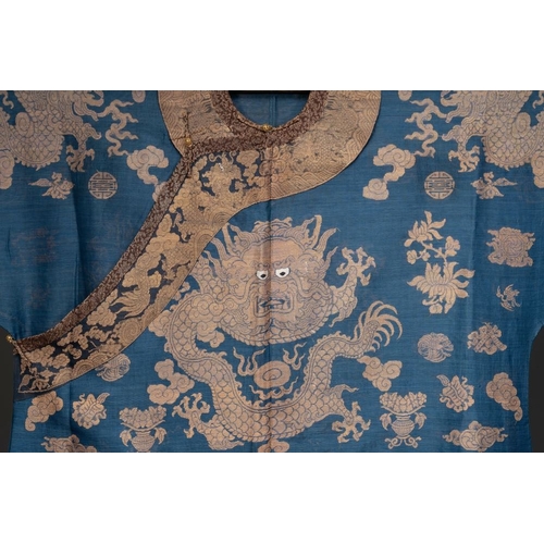 1064 - A Chinese embroidered silk blue-ground summer gauze 'nine dragons' robe, 19th C.Dim.: 215 x 130 cm... 