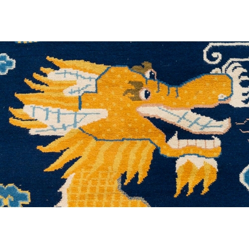 1065 - A Chinese woollen 'dragon' pillar carpet, 19th C.Dim.: 378 x 120 cm
Many Chinese Buddhist objects fr... 