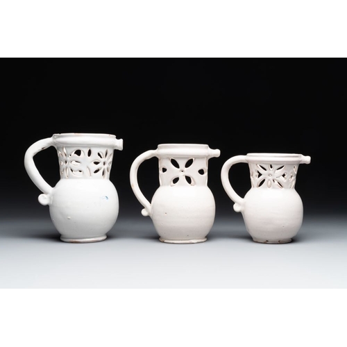 1131 - Three French white-glazed and two polychrome puzzle jugs, Nevers, 18th C.H.: 18,4 cm (the tallest)H.... 