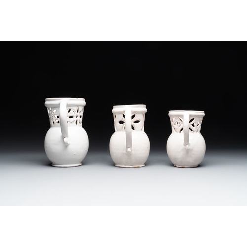 1131 - Three French white-glazed and two polychrome puzzle jugs, Nevers, 18th C.H.: 18,4 cm (the tallest)H.... 