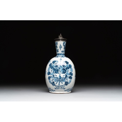 1133 - A Dutch Delft blue and white pewter-mounted armorial jug, late 17th C.H.: 26 cm
Marked with a blue W... 