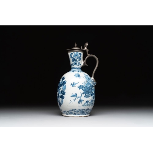 1133 - A Dutch Delft blue and white pewter-mounted armorial jug, late 17th C.H.: 26 cm
Marked with a blue W... 