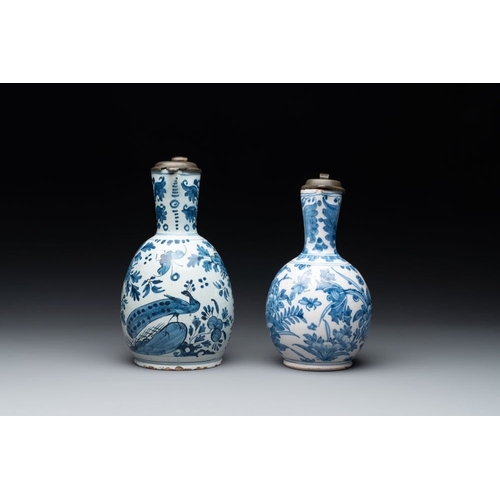 1134 - Two Dutch Delft blue and white jugs with pewter lids, 17/18th C.H.: 24,5 cm (the largest, incl. cove... 