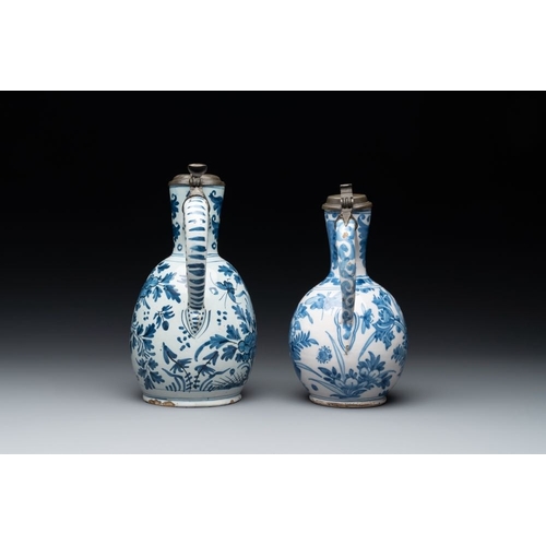 1134 - Two Dutch Delft blue and white jugs with pewter lids, 17/18th C.H.: 24,5 cm (the largest, incl. cove... 