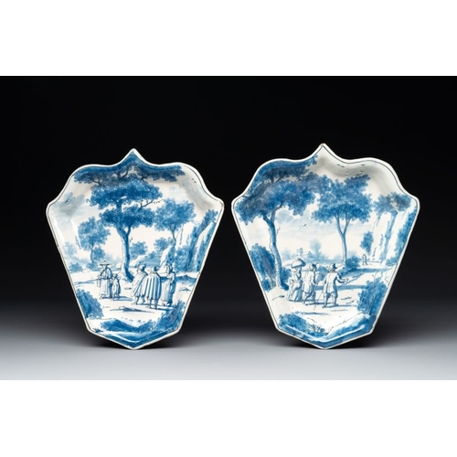 1149 - A pair of fine blue and white Dutch Delft leaf-shaped  dishes with travellers in a landscape, early ... 