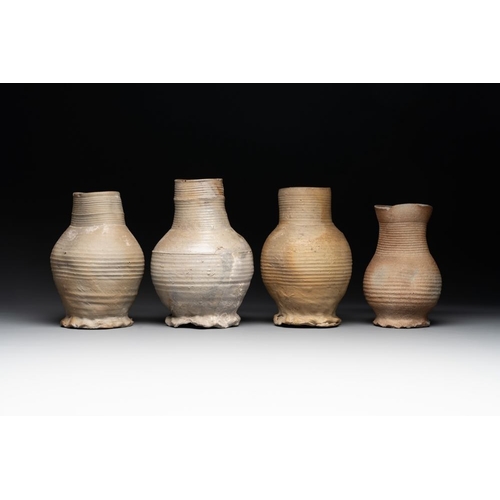 1169 - A collection of 8 German proto stoneware ribbed jugs, including 'Jacobakans', 14th C.H.: 24 cm (the ... 