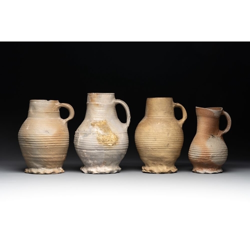 1169 - A collection of 8 German proto stoneware ribbed jugs, including 'Jacobakans', 14th C.H.: 24 cm (the ... 