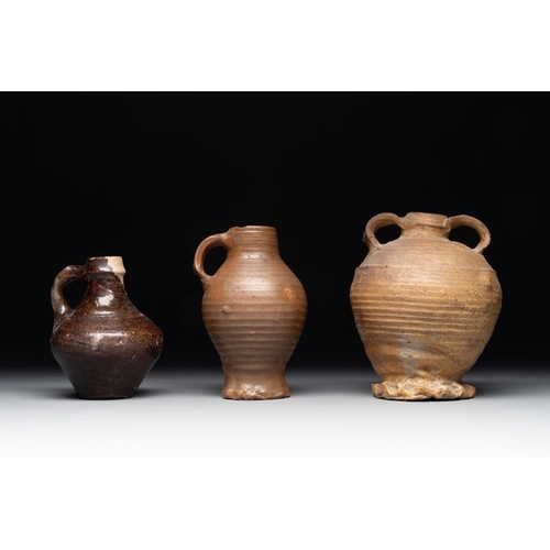 1186 - A collection of 13 German stoneware jugs, 15th C. and laterH.: 19,5 cm (the largest)H.: 9,5 cm (the ... 