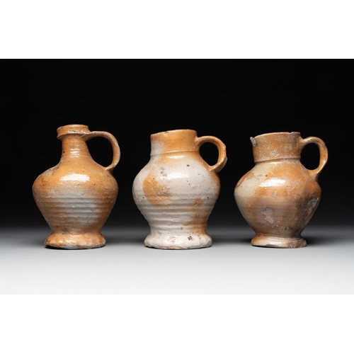 1186 - A collection of 13 German stoneware jugs, 15th C. and laterH.: 19,5 cm (the largest)H.: 9,5 cm (the ... 