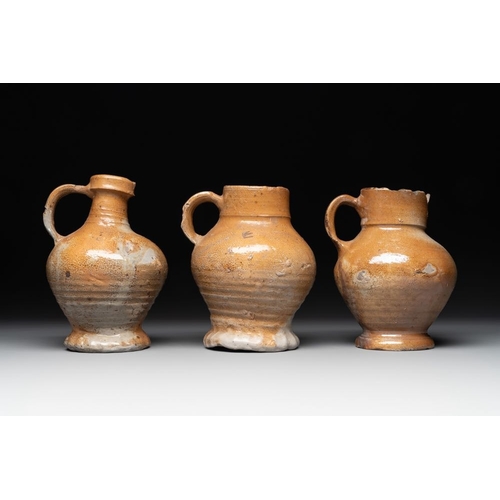 1186 - A collection of 13 German stoneware jugs, 15th C. and laterH.: 19,5 cm (the largest)H.: 9,5 cm (the ... 