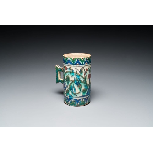 1194 - A polychrome Iznik-style mug with tulips and carnations, Kutahya, Turkey, 19th C.L.: 16,5 cm - H.: 1... 