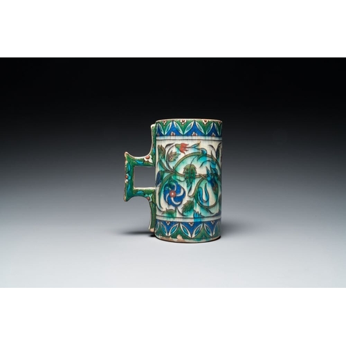 1194 - A polychrome Iznik-style mug with tulips and carnations, Kutahya, Turkey, 19th C.L.: 16,5 cm - H.: 1... 