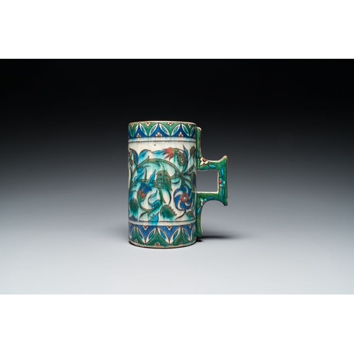 1194 - A polychrome Iznik-style mug with tulips and carnations, Kutahya, Turkey, 19th C.L.: 16,5 cm - H.: 1... 