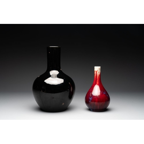 190 - A Chinese black-glazed 'tianqiu ping' vase and a flambe-glazed bottle vase, 19/20th C.H.: 32,4 cm (t... 