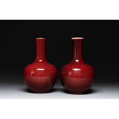 202 - A Chinese apple-green-glazed and two copper-red-glazed bottle vases, Kangxi mark, 19/20th C.H.: 33,3... 