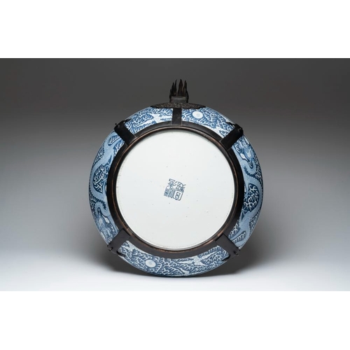 256 - A massive Chinese blue and white reverse-decorated  'dragon' charger with bronze mounts, Chuxiu Gong... 