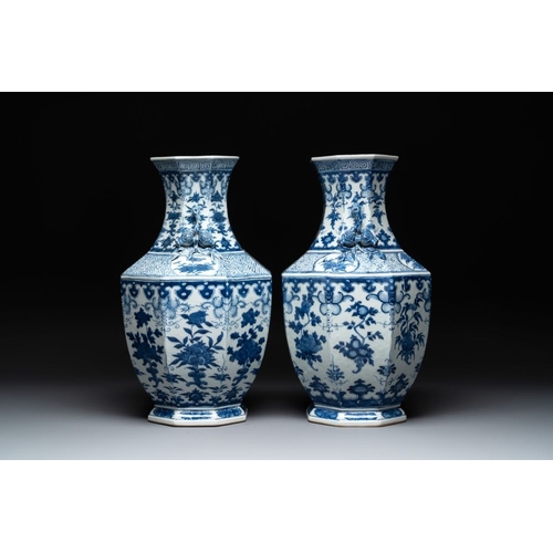 278 - A pair of Chinese blue and white octagonal vases with floral design, 19th C.H.: 49 cm... 